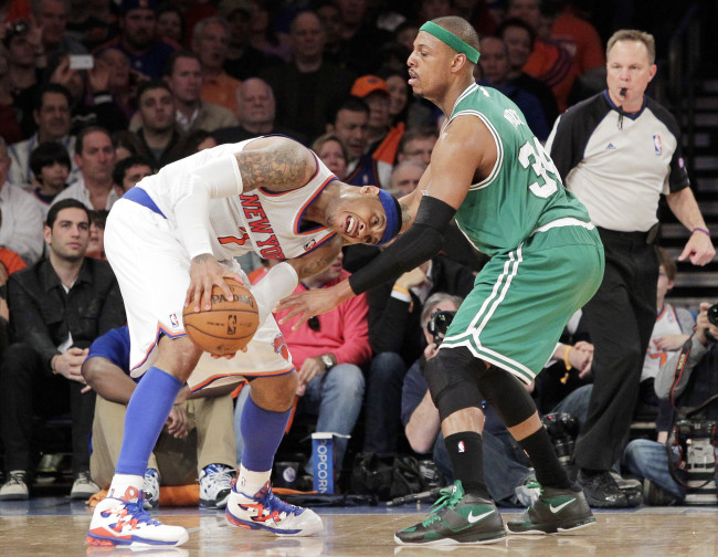 New York Knicks forward Carmelo Anthony looks to drive on Boston Celtics forward Paul Pierce on Saturday.   UPI-Yonhap News