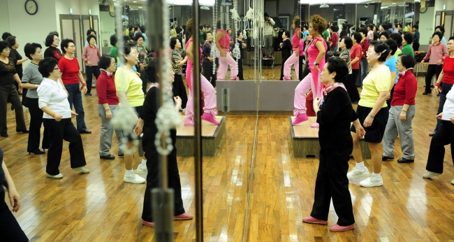 A group of seniors takes part in an aerobics class in Seoul.   The Korea Herald file photo
