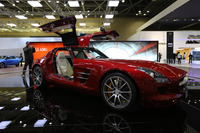 An attendee takes a photograph of the Daimler AG Mercedes-Benz SLS AMG vehicle on display during the Seoul Motor Show in Goyang on March 28.   Bloomberg