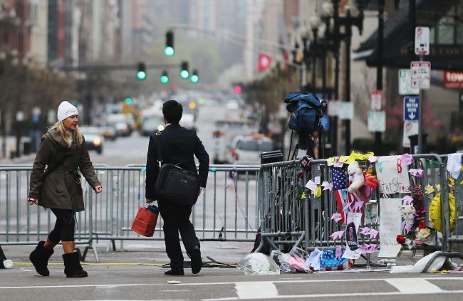 People walk past a barricade and makeshift memorial blocking a still closed section of Boylston Street near the site of the Boston Marathon bombings in Boston, Massachusetts, Tuesday.   AFP-Yonhap News