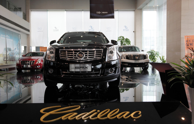 General Motors Co. Cadillac CTS (left), SRX (center) and Escalade Hybrid vehicle are displayed at a dealership in Shanghai.   Bloomberg