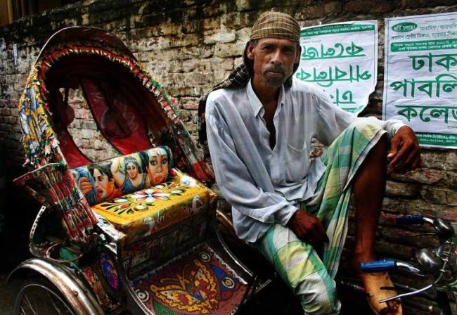 A rickshaw-puller in Dhaka dons the lungi, the traditional attire for Bangladeshi men. Rickshaw-pullers transport passengers in Dhaka.   The Daily Star