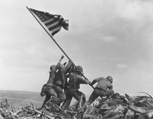 This Feb. 23, 1945, file photo shows U.S. Marines of the 28th Regiment, 5th Division, raising the American flag atop Mount Suribachi in Iwo Jima, Japan.   AP-Yonhap News