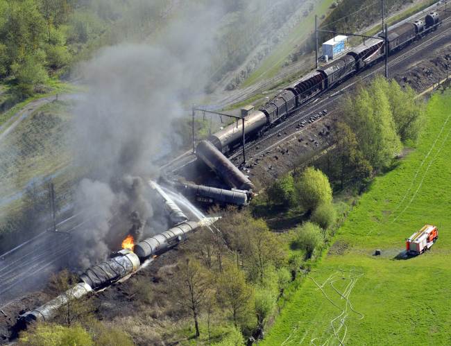 An exploded freight train smoulders near Schellebelle, 20 kilometers east of Ghent, Belgium, Saturday.   AFP-Yonhap News