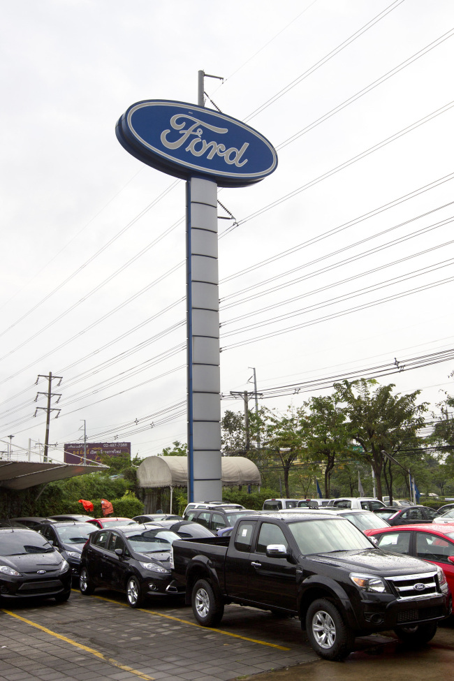 Cars sit outside a Ford Motor Co. dealership in Bangkok.   Bloomberg