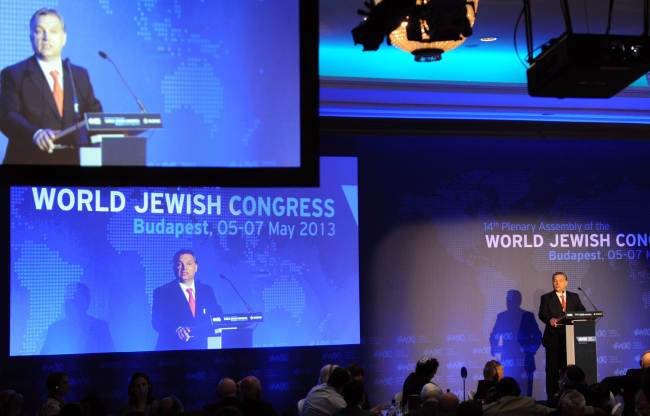 Hungarian Prime Minister Viktor Orban delivers a speech as he is seen on displays during an opening ceremony of the 14th Plenary Assembly of the World Jewish Congress in Budapest on Sunday.   AFP-Yonhap News