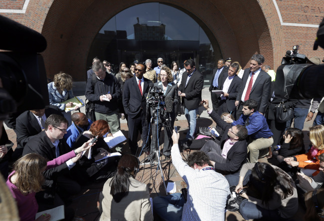 Derege Demissie (center left) and Susan Church (center right), defense attorneys for Robel Phillipos, face members of the media in front of federal court in Boston on Monday.   AP-Yonhap News