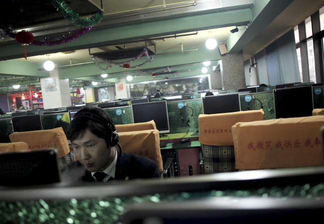 A man uses computers at an Internet cafe in Shanghai.   Bloomberg