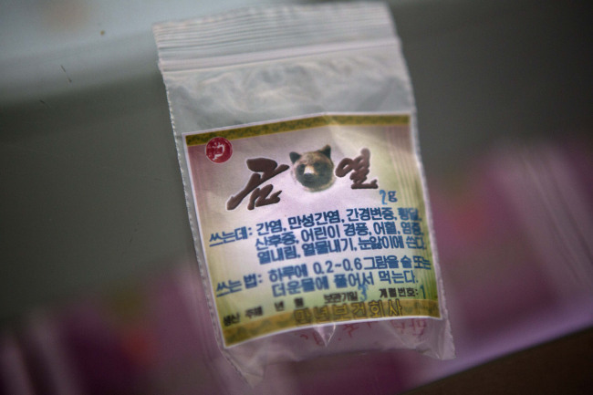A sachet of powdered bear bile sits in a display case at the Man Nyon Pharmacy.   AP-Yonhap News