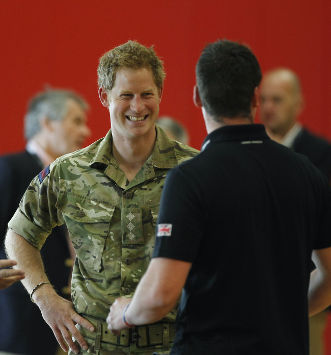 Britain’s Prince Harry talks with members of the British Warrior Games Team.   AP-Yonhap News