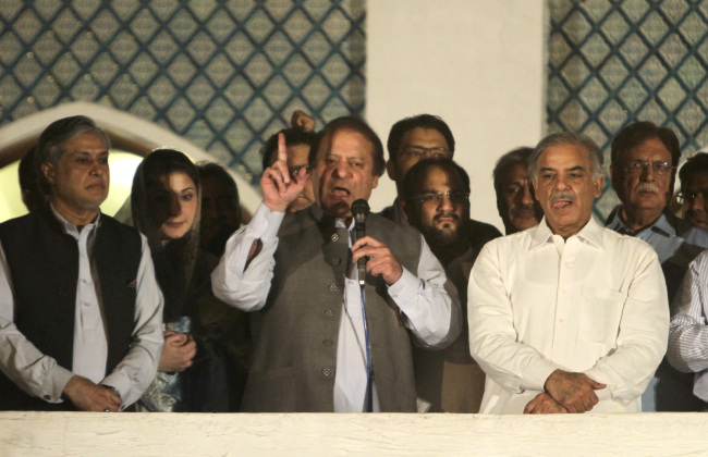 Former Prime Minister and leader of the Pakistan Muslim League-N party Nawaz Sharif (center) addresses his supporters as his brother Shahbaz Sharif (right) and daughter Maryam Nawaz (second from left) listen at a party office in Lahore, Pakistan, Saturday.   AP-Yonhap News