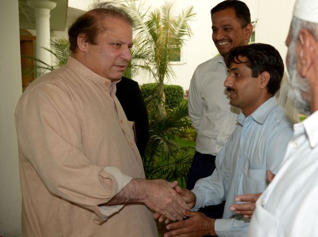 Former Pakistani Prime Minister and head of the Pakistan Muslim League-N Nawaz Sharif (left) meets party supporters at his residence in Lahore, Pakistan, Sunday.   AFP-Yonhap News