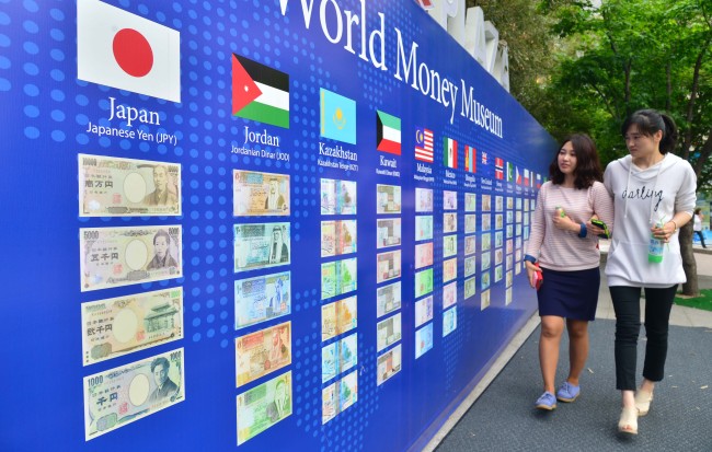 People walk past World Money Museum installed in Myeong-dong, central Seoul, Tuesday.   Lee Sang-sub/The Korea Herald