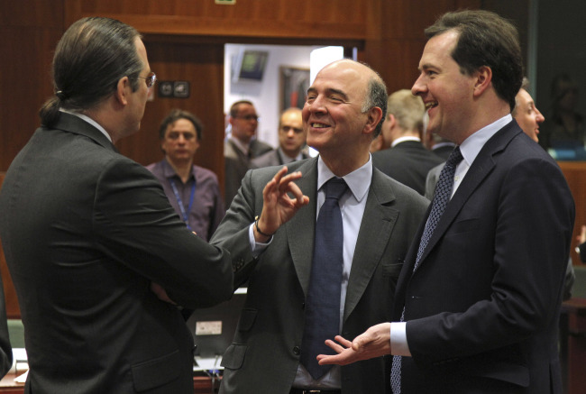 French Finance Minister Pierre Moscovici (center) talks with Swedish Finance Minister Anders Borg (left) and British Chancellor of the Exchequer George Osborne during the EU finance ministers meeting at the European Council building in Brussels on Tuesday.    AP-Yonhap News