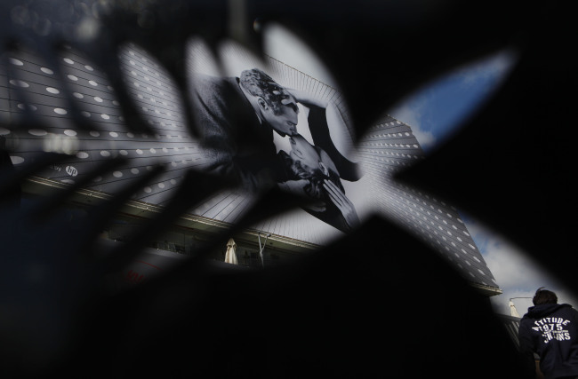 A man walks past a poster outside Palais des Festivals in Cannes, France, Tuesday.   Xinhua-Yonhap News