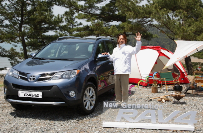A model poses with Toyota’s new RAV4 at a launch in Seoul last week.   Toyota Korea