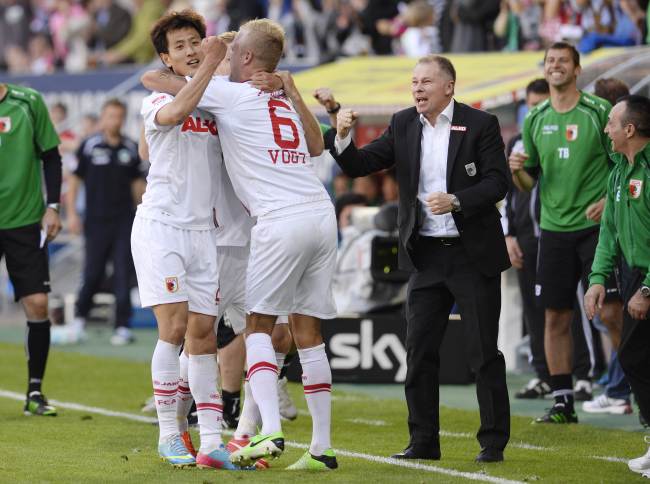 Augsburg midfielder Ji Dong-won (left) celebrates his goal on Saturday.   AFP-Yonhap News