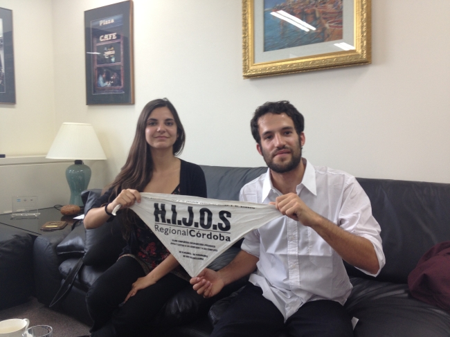 Marcos Kary (right) and Julia Parodi hold up a bandana displaying their group’s name, HIJOS, “children” in Spanish, during an interview with The Korea Herald at the Argentine Embassy in Seoul on Monday.   Philip Iglauer