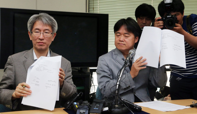 Kim Yong-jin (left), head of the Korea Center for Investigative Journalism, and producer Choi Seung-ho make public the list of Korean businessmen and their families suspected of having slush funds in overseas tax havens at a news conference in Seoul on Wednesday.   Yonhap News