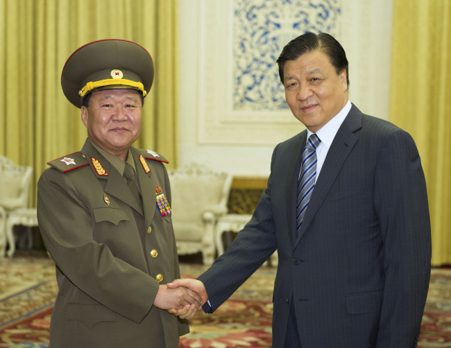 Liu Yunshan (right), a member of the Standing Committee of the Political Bureau of the Communist Party of China (CPC) Central Committee, meets with Choe Ryong-hae (left), the special envoy to the leader of the Democratic People's Republic of Korea Kim Jong-un, in Beijing. (Xinhua-Yonhap News)