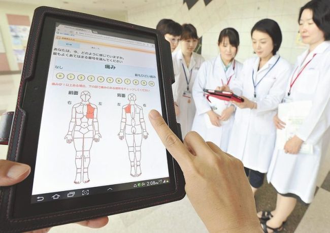 A tablet computing device for home-based cancer patients is shown at the National Cancer Center’s Hospital East in Kashiwa, Chiba prefecture, Japan.   The Japan News