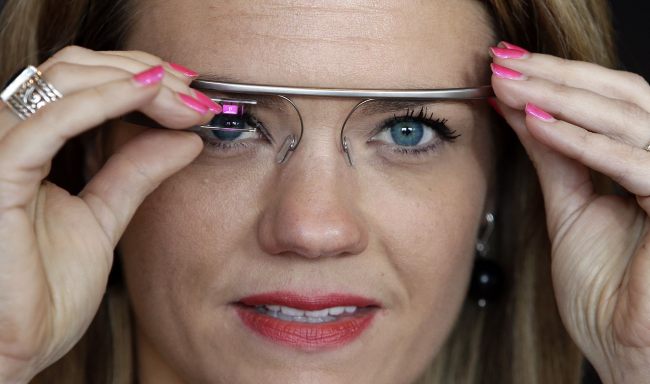 Sarah Hill, a Google Glass contest winner, reacts while trying out her device in New York on May 29.   AP-Yonhap News
