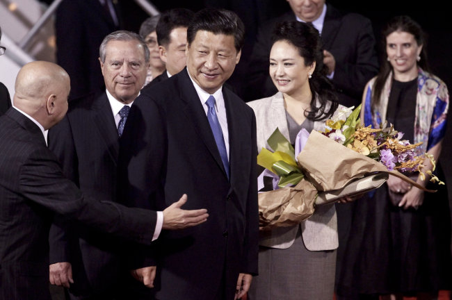 China’s President Xi Jinping (third from left) and his wife Peng Liyuan are welcomed upon their arrival to San Jose, Costa Rica, Sunday.   AP-Yonhap News