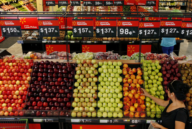 A customer shops for produce during the grand opening of a Wal-Mart Stores Inc. location in Panorama City, California.   Bloomberg