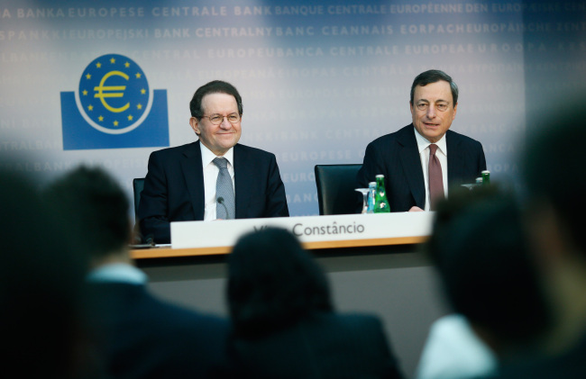 Vitor Constancio (left), vice president of the European Central Bank, reacts while Mario Draghi, president of the European Central Bank, speaks during a news conference at the bank’s headquarters in Frankfurt on Thursday.   Bloomberg
