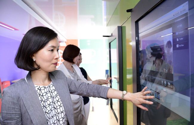A guide shows a touch screen showing travel information, maps, and promotional photos and video clips for tourists in Korea, inside a specially outfitted mobile tourist service center, launched on Tuesday by the Visit Korea Committee, a Korean tourism promotion agency. The tourist service center also offers free Wi-Fi and cell phone battery charging service. It is expected to make its first stop at the Suncheon Garden Expo Korea, currently being held in Suncheon, South Jeolla Province.   Park Hae-mook/The Korea Herald