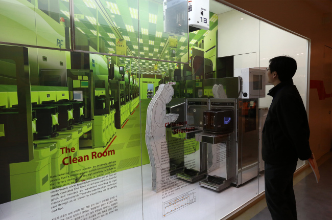A visitor looks at a display showing the clean room in the showroom of the SK Hynix Semiconductor Inc. plant in Cheongju, North Chungcheong Province.  Bloomberg