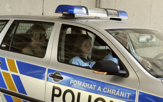 Police escort Jana Nagyova (left), the aid to Prime Minister Petr Necas, at District Court in Ostrava, Czech Republic, Saturday.   AP-Yonhap News