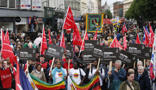 People protest opposite the G8 summit outside Belfast CIty Hall, Northern Ireland, Saturday.   AP-Yonhap News