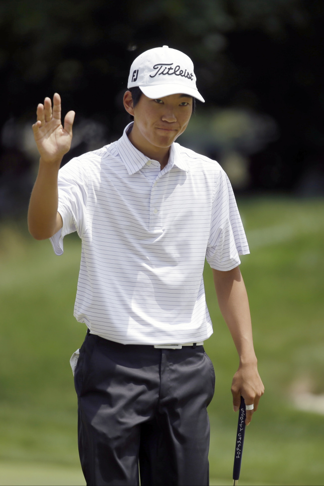 Michael Kim reacts after a birdie putt on Saturday. The 19-year-old amateur is in 10th place, five shots behind the leader.   AP-Yonhap News