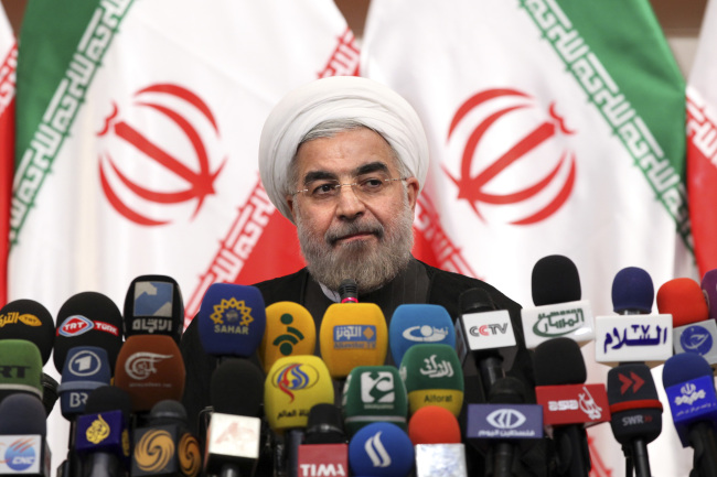 Iranian President-elect Hassan Rowhani listens to a question at a news conference in Tehran on Monday.   AP-Yonhap News