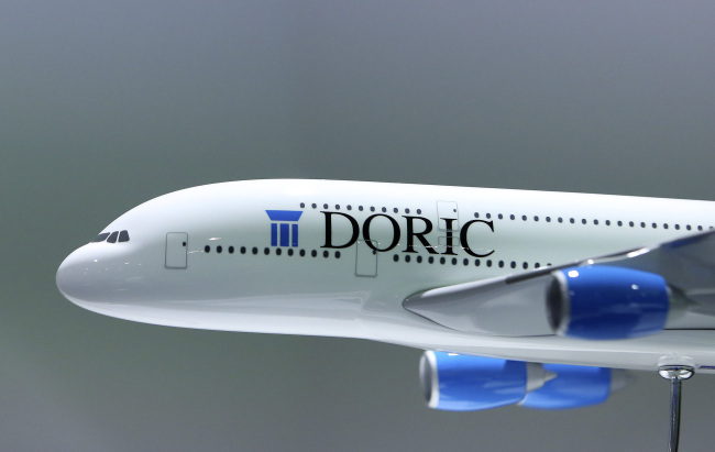 A Doric Asset Finance Ltd. logo sits on the fuselage of a model Airbus SAS A380 aircraft during the Paris Air Show.   Bloomberg