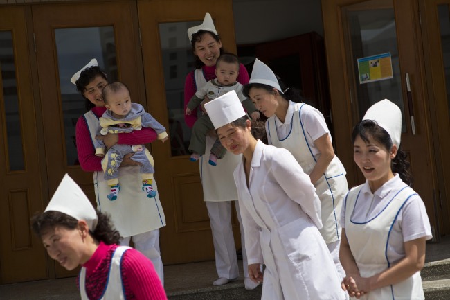 North Korean nurses say goodbye to representatives from foreign humanitarian agencies after a U.N. and North Korean government program to give vitamin supplements and deworming pills to children at a nursery school in Pyongyang, North Korea on Child Health Day.   AP-Yonhap News