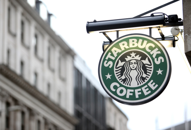 A Starbucks Corp. sign is displayed outside a coffee shop in London.   Bloomberg