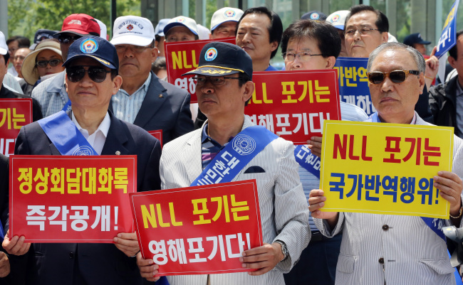 Conservative activists hold up picket signs calling for the records of the 2007 inter-Korean summit to be disclosed at a rally in Seoul on Monday. (Yonhap News)