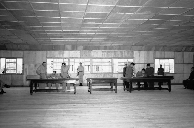 U.N. delegate Lieut. Gen. William K. Harrison (seated left), and (North) Korean People’s Army and Chinese People’s Volunteers delegate Gen. Nam Il (seated right) sign the Korean War armistice agreement at Panmunjeom on July 27, 1953.   AP