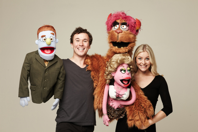 Actress Carly Anderson and actor Nicholas Duncan of “Avenue Q” pose for a photo with their character puppets in Seoul.    Seol & Company