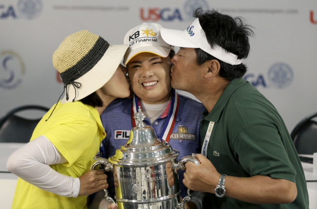 박인비(골퍼/KB금융그룹)
Park In-bee (center) poses for a picture with her trophy while her parents, Sungja Kim, left, and Gungyu Park, kiss her after she won the U.S. Women's Open golf tournament at Sebonack Golf Club in Southampton, New York, Sunday (AP-Yonhap News)