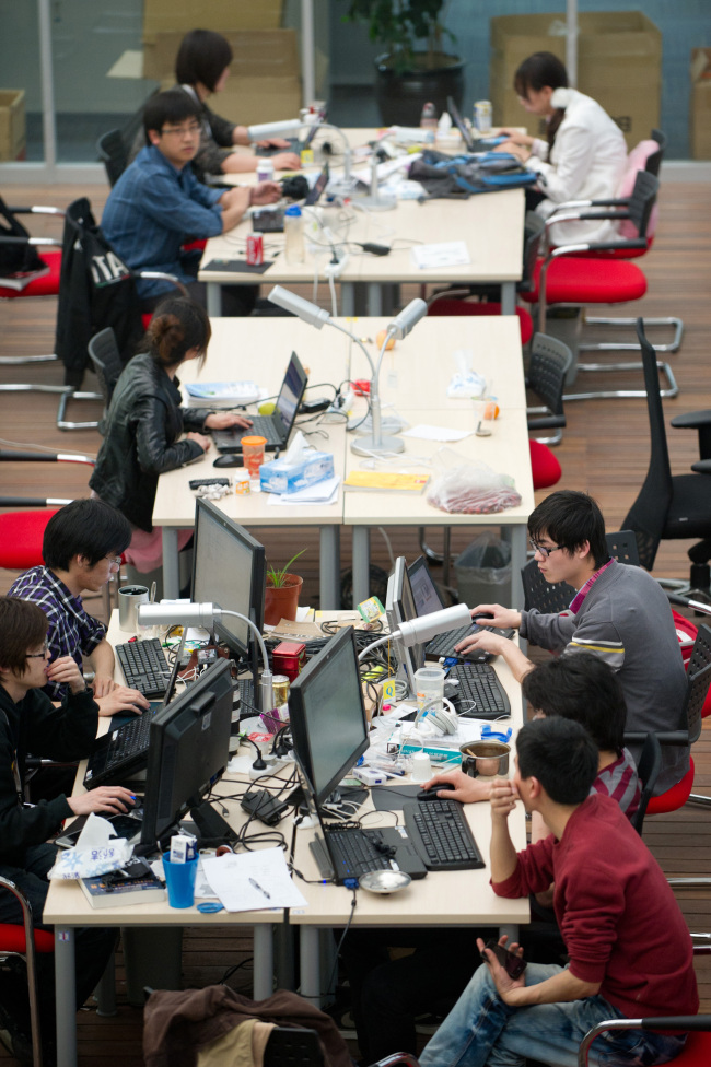 Employees work at an IT company in Beijing.   Bloomberg