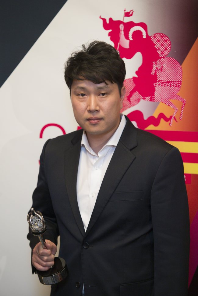 Film director Jung Young-heon holds his “The Silver George” trophy during a closing ceremony of the 35th Moscow International Film Festival in Moscow, Saturday.    AP-Yonhap News