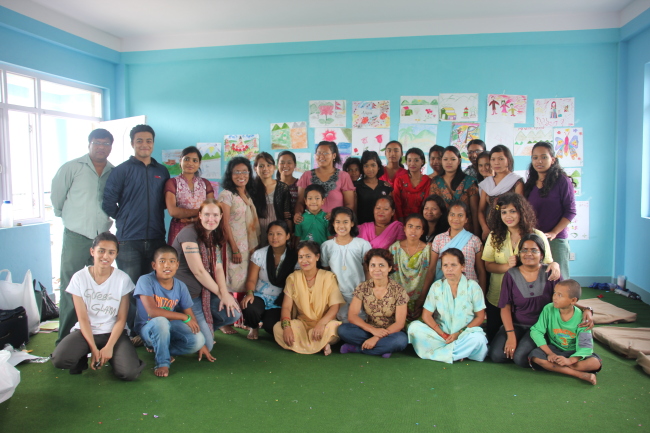 Samantha Thomas (third from left, front row) poses with participants in an art workshop she ran while volunteering for Child Workers in Nepal in Kathmandu in July 2012.