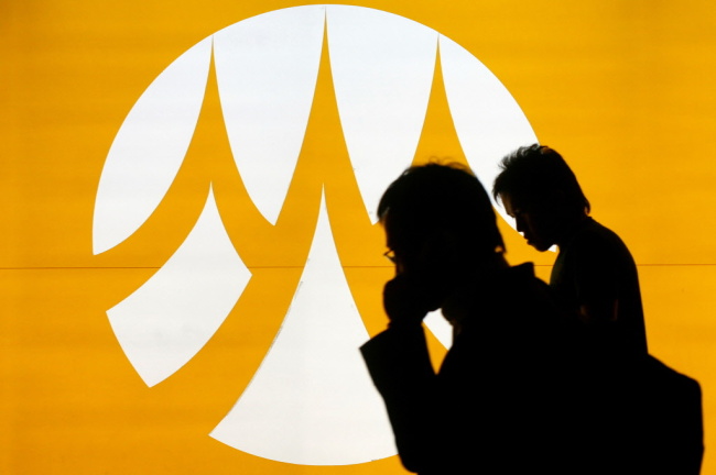 Employees walk past the Bank of Ayudhya Pcl’s branch in Bangkok.   Bloomberg