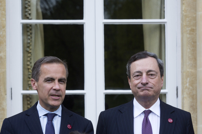 Mario Draghi (right), president of the European Central Bank, and Mark Carney, governor of Bank of England, pose during the Group of Seven finance ministers and central bank governors meeting at Hartwell House in Aylesbury on May 10.   Bloomberg
