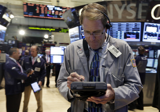 A trader works on the floor of the New York Stock Exchange.   AP-Yonhap News