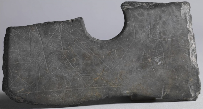 This undated photo shows a piece of a stone ax with etched markings which was unearthed near Zhuangqiao grave relic in Pinghu, Zhejiang Province, China.   AP-Yonhap News