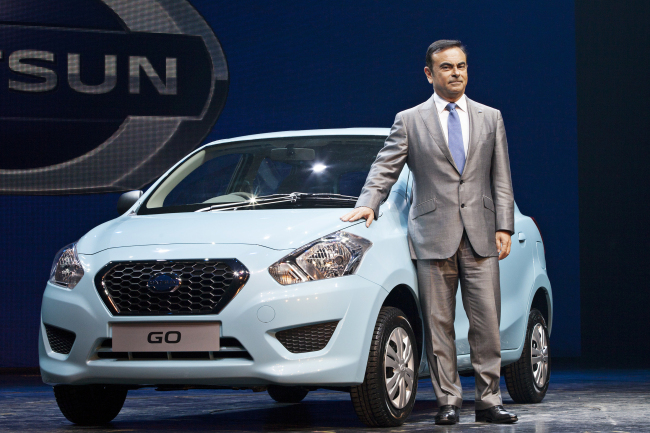 Carlos Ghosn, chief executive officer of Nissan Motor Co., stands with the company’s new Datsun Go vehicle at a media event in Gurgaon, India, Monday.   Bloomberg